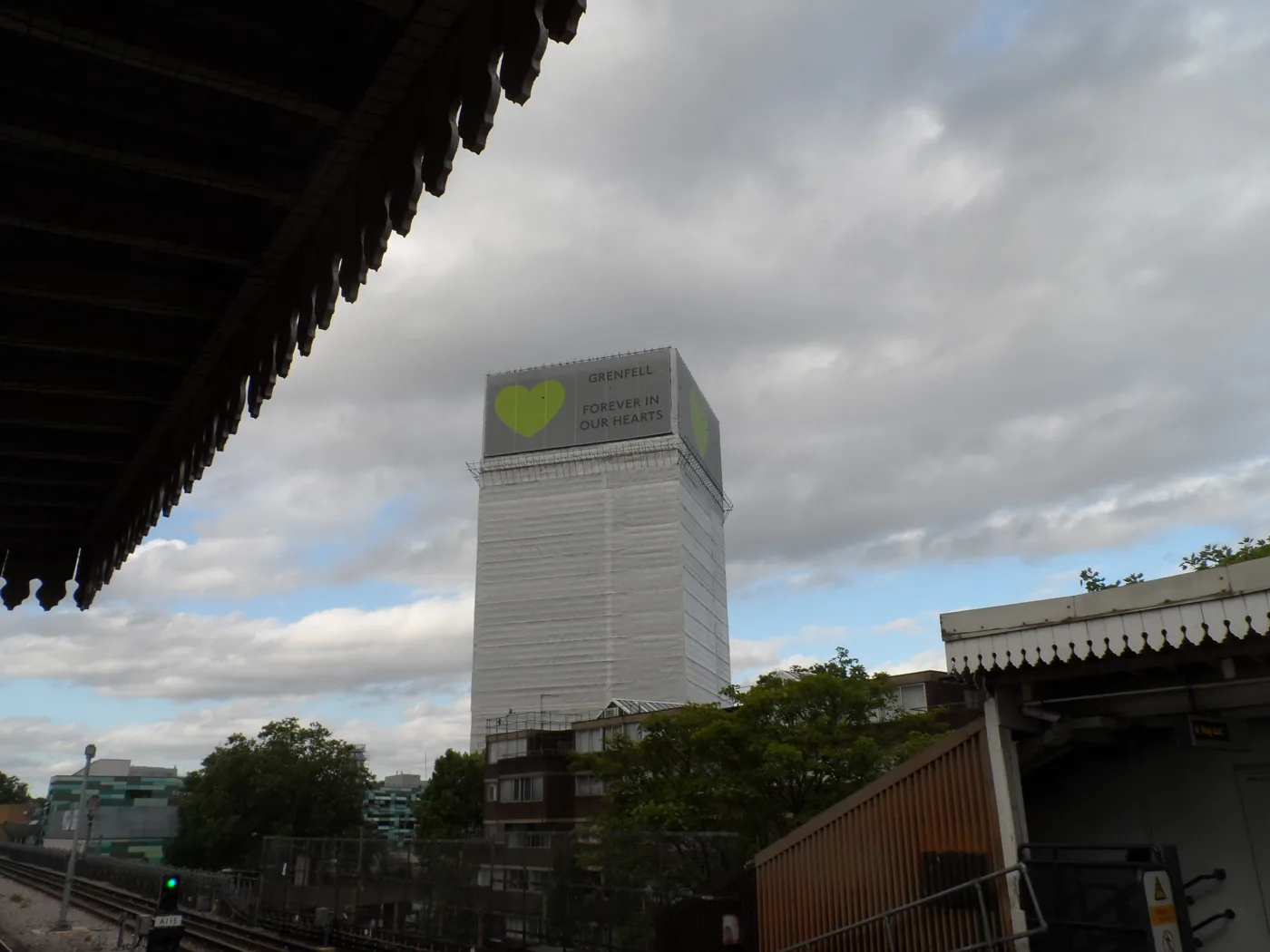 Grenfell Tower with its memorial banners in June 2018